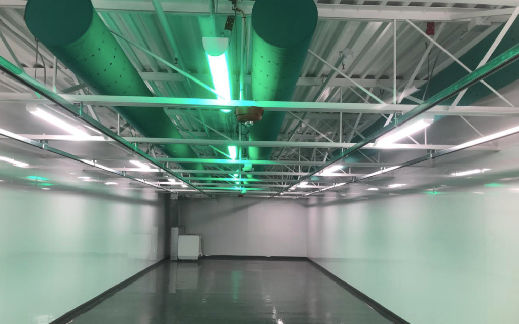 Close-up of cultivation lighting with dehumidification equipment overhead